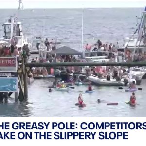 Greasy Pole Competition: the slippery slope at St. Peter's Fiesta in Gloucester, Massachusetts